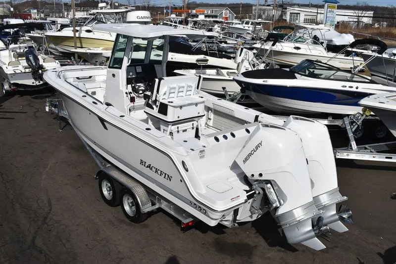 Slide: The Image of 2025 Blackfin 252CC boat with dual Mercury engines on a trailer. - 6