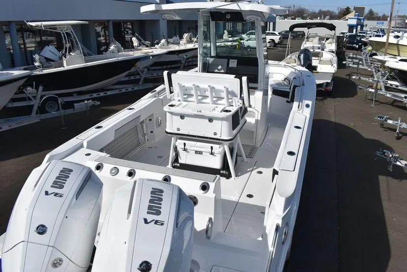 Slide: The Image of 2025 Blackfin 252CC boat with dual engines, showcased at a dealership. - 8