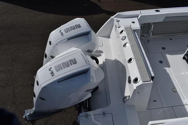 Slide: The Image of 2025 Blackfin 252CC boat with dual outboard engines, rear deck view. - 9
