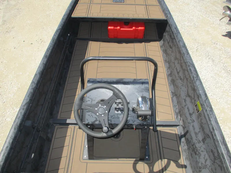 Slide: The Image of 2025 Gator Tail 1860 Extreme CC boat interior with steering console and red fuel tank. - 7