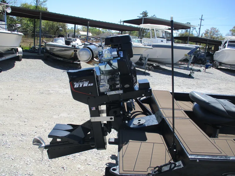 Slide: The Image of 2025 Gator Tail 1860 Extreme CC boat motor in a marina setting. - 9
