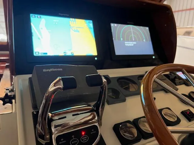 Slide: The Image of Control panel of 2001 Little Harbor WhisperJet 44 with navigation screens and steering wheel. - 16