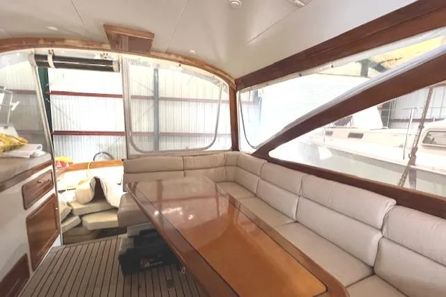 Slide: The Image of Interior of 2001 Little Harbor WhisperJet 44 yacht with elegant seating and wooden table. - 18