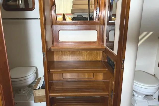 Slide: The Image of Wooden interior stairs on a 2001 Little Harbor WhisperJet 44 yacht, flanked by two toilets. - 21