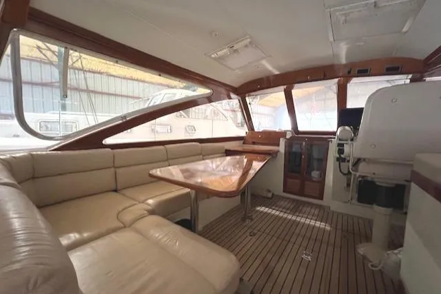 Slide: The Image of Interior of 2001 Little Harbor WhisperJet 44 with beige seating and wooden accents. - 22