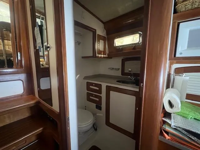 Slide: The Image of Interior of 2001 Little Harbor WhisperJet 44 yacht bathroom with wooden cabinetry. - 27
