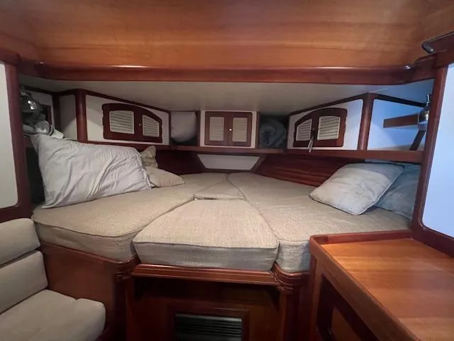 Slide: The Image of Cozy cabin interior of 2001 Little Harbor WhisperJet 44 with cushioned bed and wooden accents. - 28