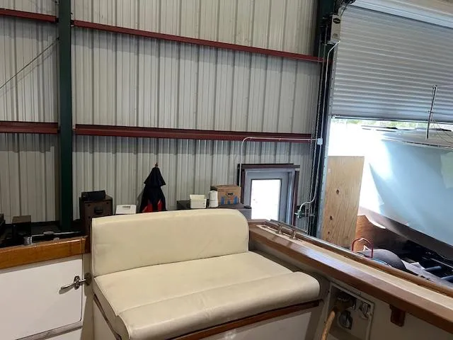 Slide: The Image of 2001 Little Harbor WhisperJet 44 interior with white seating in a storage facility. - 32