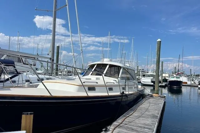 Slide: The Image of Little Harbor WhisperJet 44, 2001 model, docked at a marina under a clear blue sky. - 4