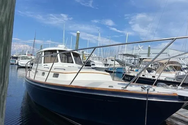 Slide: The Image of 2001 Little Harbor WhisperJet 44 docked in a marina under a clear blue sky. - 8