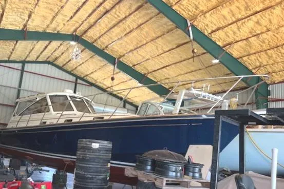 Slide: The Image of 2001 Little Harbor WhisperJet 44 boat stored in a spacious indoor facility. - 9