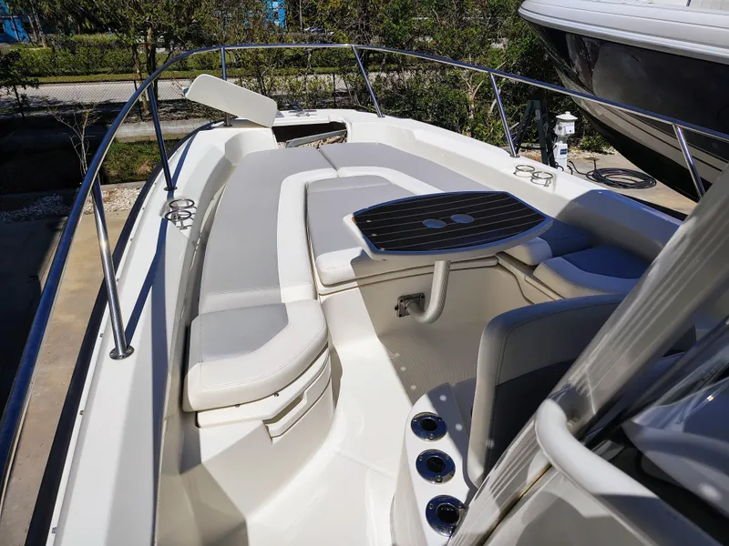 Slide: The Image of 2015 Boston Whaler 240 Dauntless boat interior with cushioned seating and table. - 15