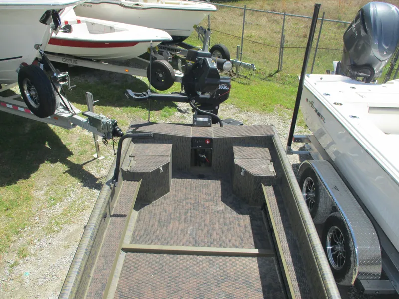 Slide: The Image of 2025 Gator Tail 1750 Savage boat on trailer, surrounded by other boats. - 4