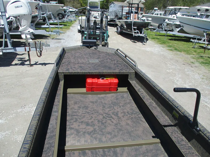 Slide: The Image of 2025 Gator Tail 1750 Savage boat with red fuel tank, parked among other boats. - 6