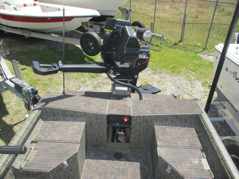 Slide: The Image of 2025 Gator Tail 1750 Savage boat with motor, parked outdoors. - 8