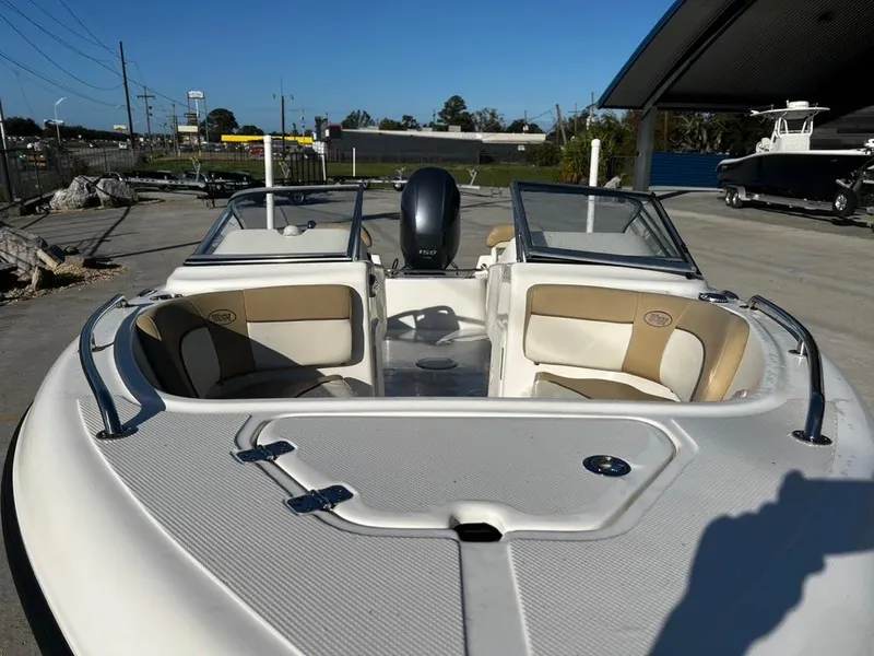 Slide: The Image of 2018 Key West 186 DC boat with open seating and dual consoles in a marina setting. - 9