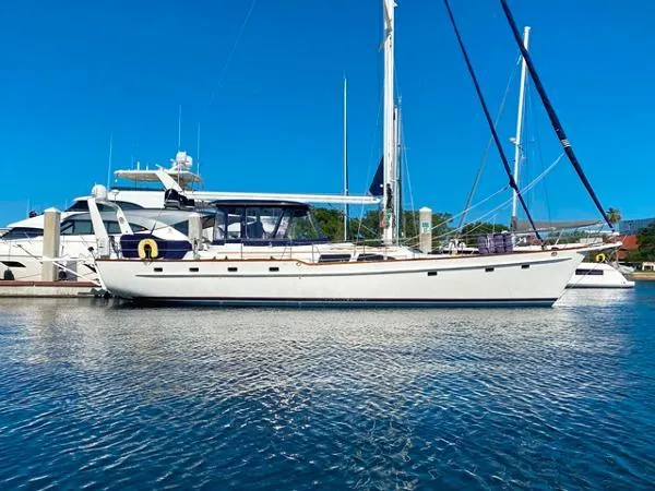 The Image of 1989 Irwin 54 sailboat docked in marina under clear blue sky. - 0