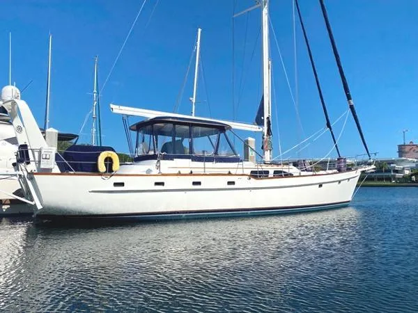 Slide: The Image of 1989 Irwin 54 sailboat docked in marina under clear blue sky. - 1