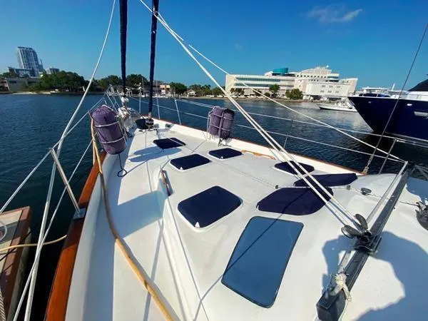 Slide: The Image of 1989 Irwin 54 sailboat deck with cityscape and marina in the background. - 12