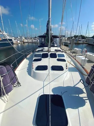 Slide: The Image of 1989 Irwin 54 sailboat docked at a marina under a clear blue sky. - 13