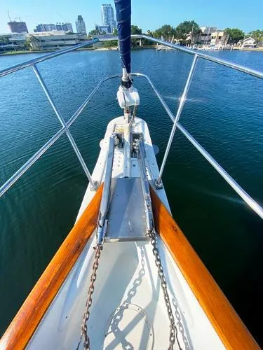 Slide: The Image of Bow view of 1989 Irwin 54 sailboat on calm water, city skyline in background. - 14