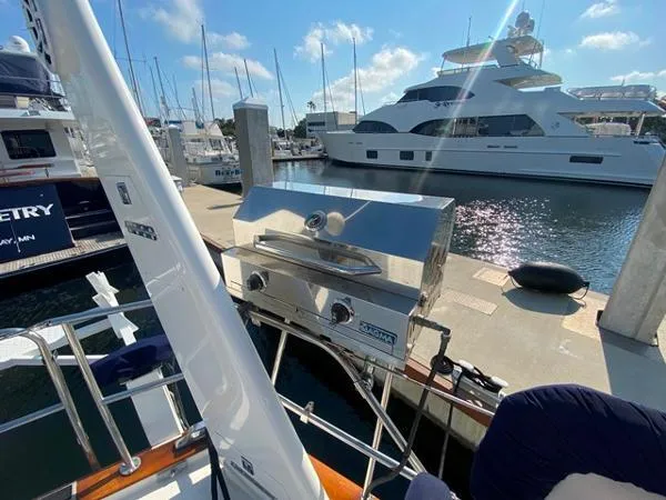 Slide: The Image of Sailboat docked with stainless steel grill, Irwin 54, 1989 model, in a sunny marina. - 17