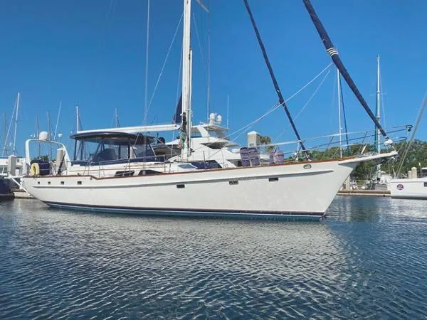 Slide: The Image of 1989 Irwin 54 yacht docked in a marina under clear blue skies. - 2