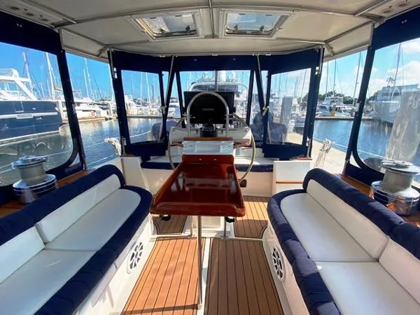 Slide: The Image of Interior view of 1989 Irwin 54 yacht with seating and helm, docked at marina. - 21
