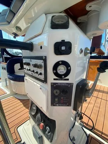 Slide: The Image of Control panel of a 1989 Irwin 54 yacht with navigation instruments and teak flooring. - 24