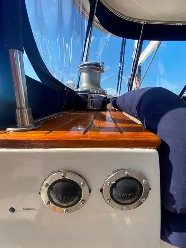 Slide: The Image of 1989 Irwin 54 sailboat deck with winch and polished wood finish. - 26