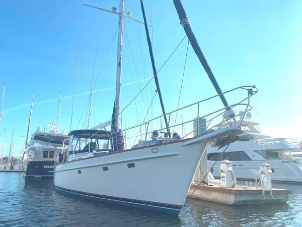 Slide: The Image of 1989 Irwin 54 sailboat docked at a marina under clear blue skies. - 3