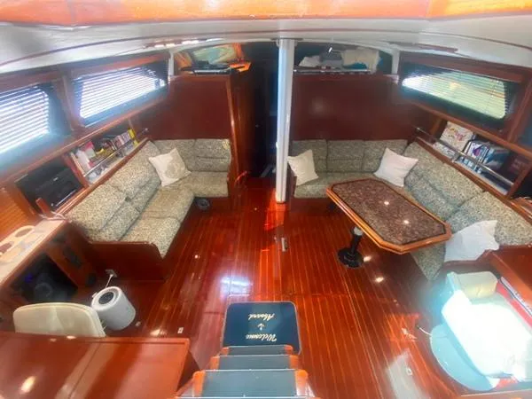 Slide: The Image of Luxurious interior of a 1989 Irwin 54 yacht with elegant wood finishes and comfortable seating. - 32