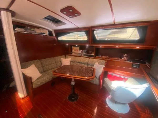Slide: The Image of Cozy interior of 1989 Irwin 54 yacht with seating, table, and wood finish. - 33