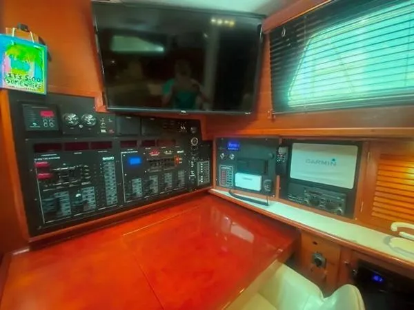 Slide: The Image of Navigation station of a 1989 Irwin 54 yacht with control panels and Garmin equipment. - 35