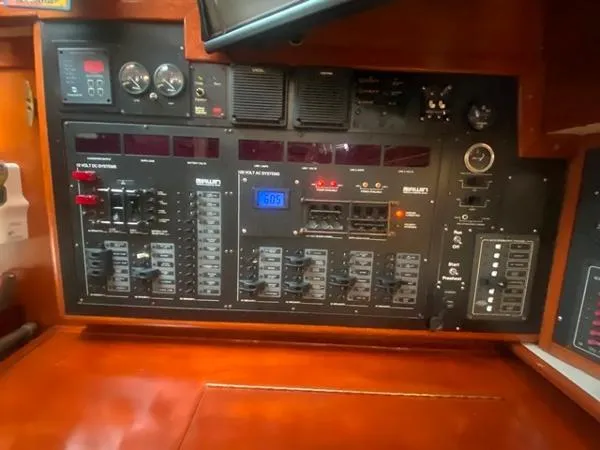 Slide: The Image of Electrical control panel on a 1989 Irwin 54 yacht, featuring various switches and gauges. - 37