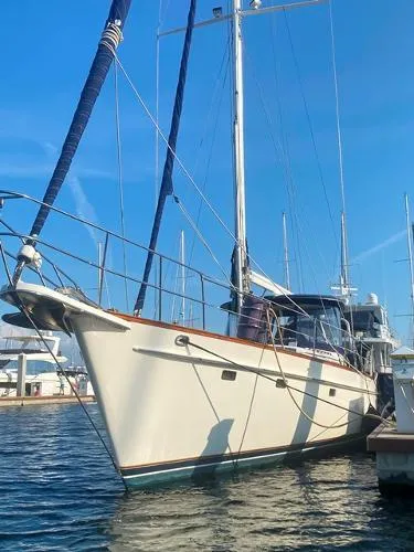 Slide: The Image of 1989 Irwin 54 sailboat docked in a marina under clear blue skies. - 4