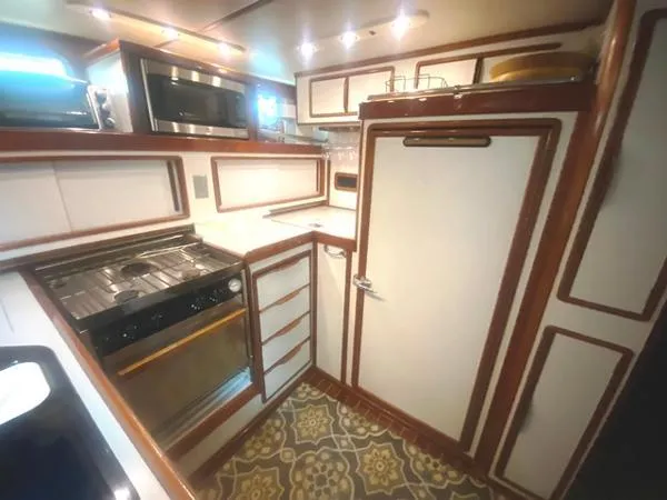 Slide: The Image of 1989 Irwin 54 yacht kitchen with modern appliances and stylish wood trim. - 41