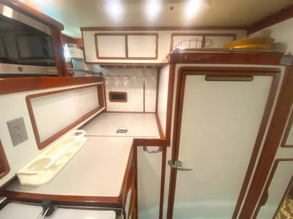 Slide: The Image of 1989 Irwin 54 yacht kitchen with white cabinetry and wood trim. - 42
