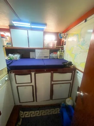 Slide: The Image of Interior of 1989 Irwin 54 sailboat with storage cabinets and nautical map. - 45