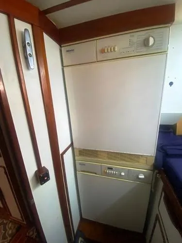 Slide: The Image of 1989 Irwin 54 yacht interior with built-in appliance, wooden trim, and compact design. - 46
