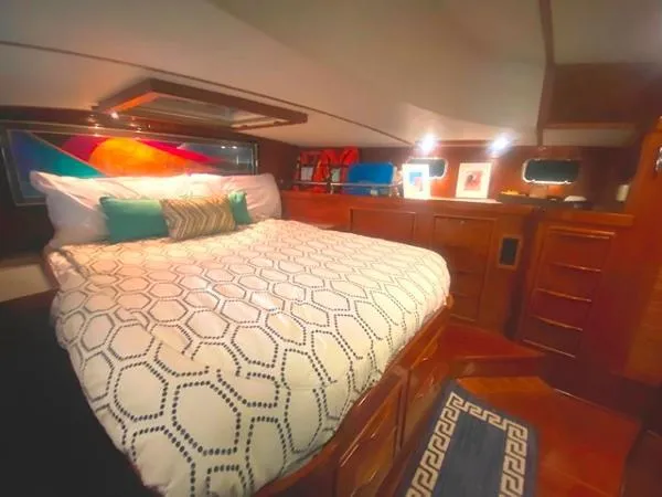 Slide: The Image of Luxurious cabin interior of a 1989 Irwin 54 yacht with a cozy bed and vibrant decor. - 48