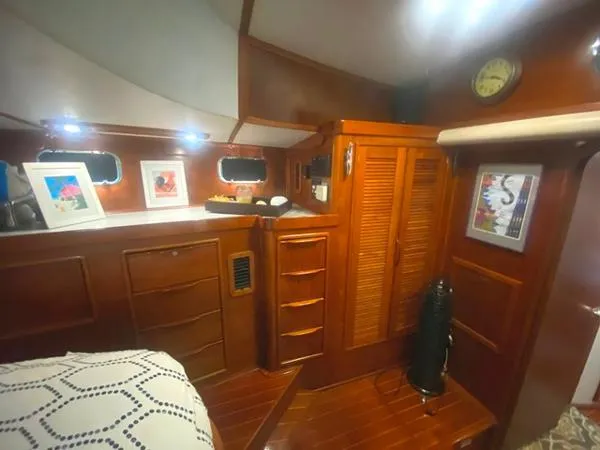 Slide: The Image of Luxurious wooden interior of 1989 Irwin 54 yacht cabin with elegant decor and storage. - 49