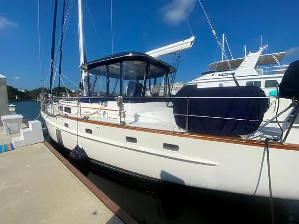 Slide: The Image of 1989 Irwin 54 sailboat docked under clear blue sky. - 7