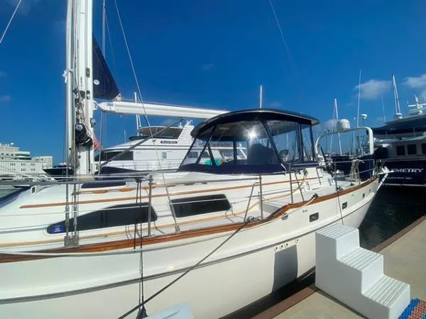 Slide: The Image of 1989 Irwin 54 sailboat docked at marina under clear blue sky. - 8