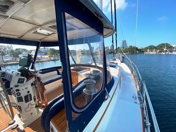 Slide: The Image of 1989 Irwin 54 yacht deck with helm, seating, and marina view. - 9