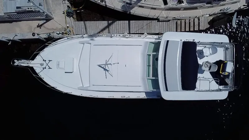 Slide: The Image of Top view of a 1974 Bertram 42 Motor Yacht docked at a marina. - 2