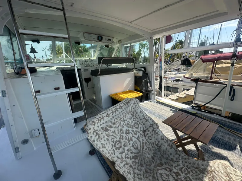 Slide: The Image of 1974 Bertram 42 Motor Yacht interior with seating, table, and helm station. - 33