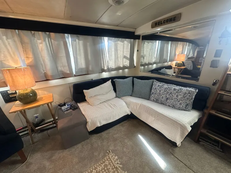 Slide: The Image of Interior of a 1974 Bertram 42 Motor Yacht with cozy seating and decorative pillows. - 39
