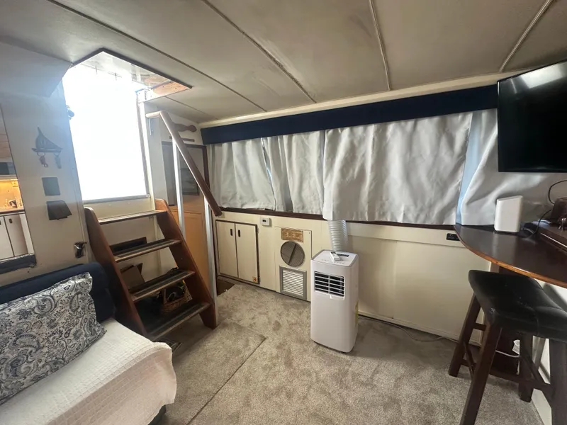 Slide: The Image of 1974 Bertram 42 Motor Yacht interior with stairs, seating, and modern amenities. - 40