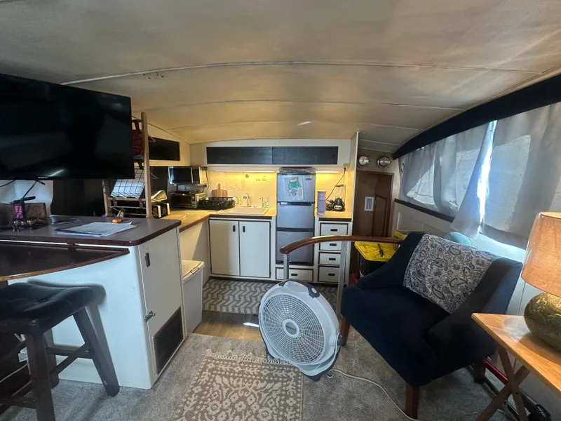 Slide: The Image of Interior of a 1974 Bertram 42 Motor Yacht with cozy living area and kitchen. - 43